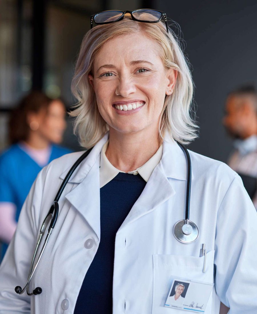 smiling-mature-female-physician-in-hospital-TJQVMX3.jpg